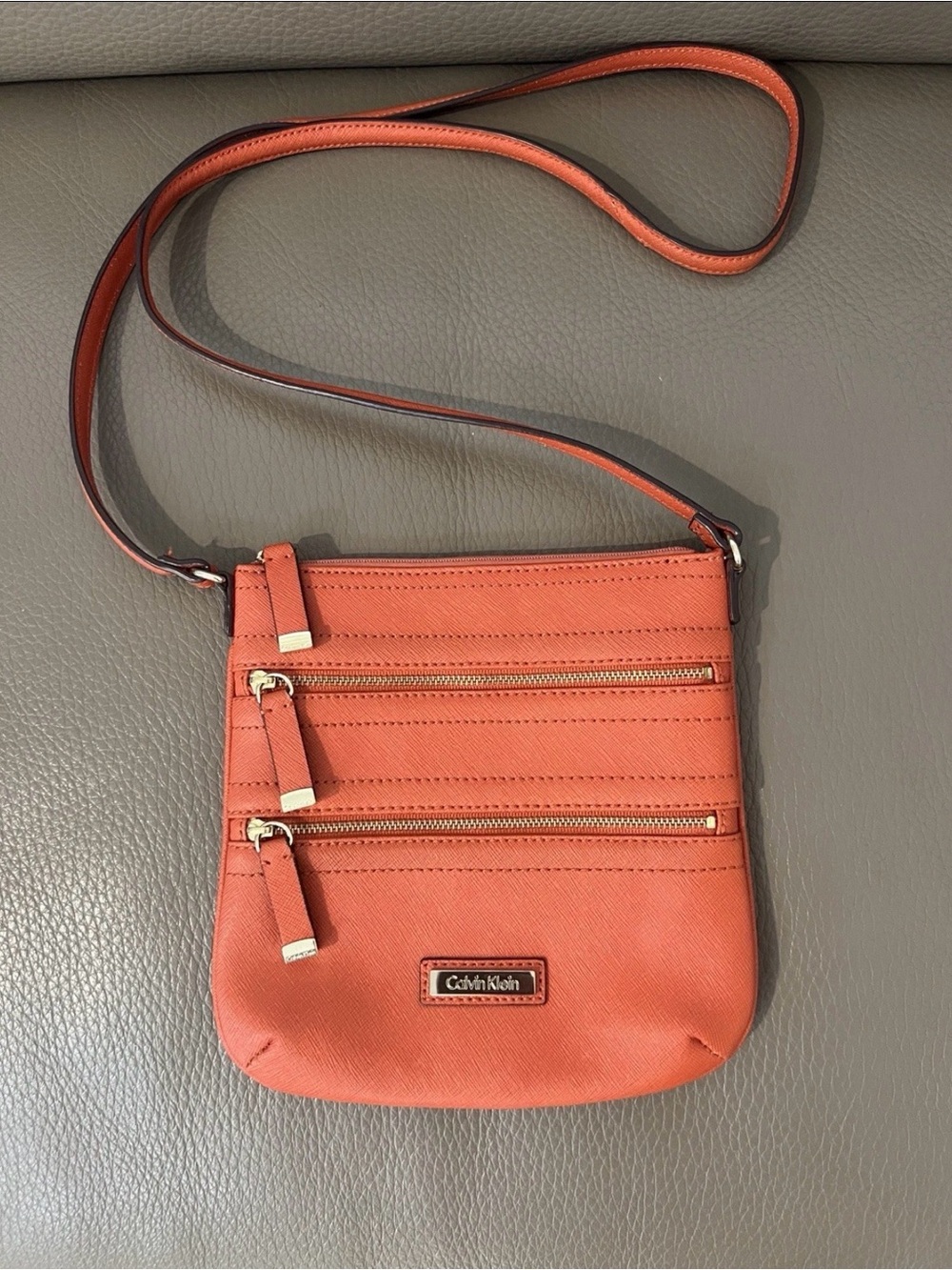 Calvin Klein Coral-Orange Crossbody Bag with Triple Zip Front